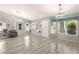 Bright and airy living room with gray floors and a view of the entryway at 3940 Colonial Field Ave, North Las Vegas, NV 89031