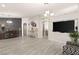 Spacious living area with gray floors, a large TV niche and a view of the kitchen at 3940 Colonial Field Ave, North Las Vegas, NV 89031