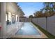 Long rectangular pool with covered patio and grassy backyard at 3940 Colonial Field Ave, North Las Vegas, NV 89031