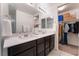 Main bathroom with double vanity and walk-in closet at 406 Misterioso St, Henderson, NV 89011