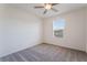 Spacious bedroom with grey carpet, ceiling fan, and window with blinds at 406 Misterioso St, Henderson, NV 89011