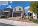 Two-story house with gray exterior, brown garage door, and landscaped front yard at 406 Misterioso St, Henderson, NV 89011