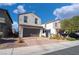 Two-story house with gray exterior, brown garage door, and landscaped front yard at 406 Misterioso St, Henderson, NV 89011