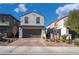 Two-story house with gray exterior, brown garage door, and landscaped front yard at 406 Misterioso St, Henderson, NV 89011