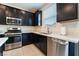 Kitchen with stainless steel appliances and white countertops at 406 Misterioso St, Henderson, NV 89011