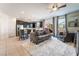 Open concept living room and kitchen with gray sofas and island at 406 Misterioso St, Henderson, NV 89011