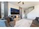 Living room with gray sofas, large TV, and view of stairs at 406 Misterioso St, Henderson, NV 89011