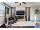 Living room with gray armchairs, large TV, and fluffy rug at 406 Misterioso St, Henderson, NV 89011