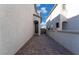 Brick paved walkway between two light gray houses at 406 Misterioso St, Henderson, NV 89011