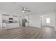 Open living room and kitchen with grey flooring and ceiling fan at 4253 Gold Desert St, North Las Vegas, NV 89032