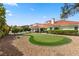 Landscaped backyard with putting green and partial view of pool at 43 Innisbrook Ave, Las Vegas, NV 89113