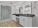 Modern bathroom with double sinks, walk-in shower, and hardwood floors at 43 Innisbrook Ave, Las Vegas, NV 89113