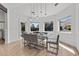 Modern dining room with glass table and grey cushioned chairs at 43 Innisbrook Ave, Las Vegas, NV 89113