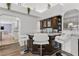 Elegant home bar with marble countertop and modern white barstools at 43 Innisbrook Ave, Las Vegas, NV 89113