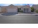 One-story house with attached garage and desert landscaping at 4613 Golden Palomino Ln, North Las Vegas, NV 89032