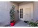 Front entry with security door and large potted plant at 4613 Golden Palomino Ln, North Las Vegas, NV 89032