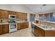 Well-equipped kitchen with stainless steel appliances and breakfast bar at 4613 Golden Palomino Ln, North Las Vegas, NV 89032