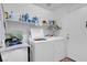 Laundry room with washer, dryer, and storage shelves at 4613 Golden Palomino Ln, North Las Vegas, NV 89032