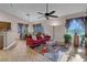 Living room with red couch, ceiling fan and tile floors at 4613 Golden Palomino Ln, North Las Vegas, NV 89032