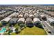 Aerial view of a well-planned community with a pool, green space, and rows of houses at 4710 Frasers Owl Ave # 103, North Las Vegas, NV 89084