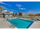 Community pool with lounge chairs and gated access at 4710 Frasers Owl Ave # 103, North Las Vegas, NV 89084