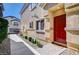 Red front door with a brick walkway and landscaping at 4710 Frasers Owl Ave # 103, North Las Vegas, NV 89084