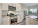 Modern kitchen with stainless steel appliances and white cabinets at 4710 Frasers Owl Ave # 103, North Las Vegas, NV 89084