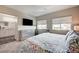 Spacious main bedroom with a large bed and TV at 4710 Frasers Owl Ave # 103, North Las Vegas, NV 89084