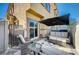 Patio with wicker furniture, umbrella, and sliding door access at 4710 Frasers Owl Ave # 103, North Las Vegas, NV 89084