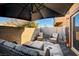 Relaxing patio with wicker furniture and umbrella at 4710 Frasers Owl Ave # 103, North Las Vegas, NV 89084