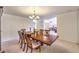 Bright dining room with a large table, chandelier, and view to living room at 4780 Mack Ct, Pahrump, NV 89060