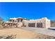 Two-story home with stucco exterior, attached garage, and desert landscaping at 4780 Mack Ct, Pahrump, NV 89060