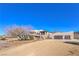 Two-story home with stucco exterior, attached garage, and desert landscaping at 4780 Mack Ct, Pahrump, NV 89060