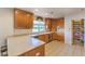 L-shaped kitchen with oak cabinets, stainless steel appliances, and a large window at 4780 Mack Ct, Pahrump, NV 89060