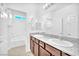 Bathroom with double sinks, granite countertops, and a shower/tub enclosure at 5640 Akula Bay St, North Las Vegas, NV 89081
