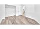 Bright bedroom featuring wood-look flooring and a closet for ample storage at 5640 Akula Bay St, North Las Vegas, NV 89081