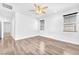 Spacious bedroom with ceiling fan, wood-look floors and natural light at 5640 Akula Bay St, North Las Vegas, NV 89081