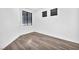 Bedroom with wood-look flooring and a large window with blinds at 5640 Akula Bay St, North Las Vegas, NV 89081