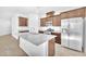 Bright kitchen features granite countertops, an island with sink, and stainless steel appliances at 5640 Akula Bay St, North Las Vegas, NV 89081