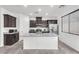 Stylish kitchen featuring a granite island, stainless appliances, and dark cabinetry at 5640 Akula Bay St, North Las Vegas, NV 89081