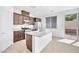 Bright kitchen features granite countertops, an island with sink, and backyard access at 5640 Akula Bay St, North Las Vegas, NV 89081