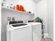 Bright laundry room with modern, front-loading washing machine and dryer at 5640 Akula Bay St, North Las Vegas, NV 89081