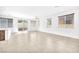 Bright living room featuring tile floors, backyard access, and multiple windows at 5640 Akula Bay St, North Las Vegas, NV 89081