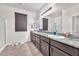 Well-lit primary bath features a dual sink vanity and a glass-enclosed shower at 5640 Akula Bay St, North Las Vegas, NV 89081