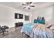 Bright main bedroom with ceiling fan, wood-look floors and ample space for furniture at 5640 Akula Bay St, North Las Vegas, NV 89081