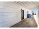 Backyard with covered patio, access gate, and trash receptacles at 6005 W Washington Ave, Las Vegas, NV 89107