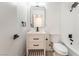 Modern bathroom with white vanity, bathtub, and black fixtures at 6005 W Washington Ave, Las Vegas, NV 89107