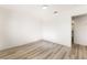 Spacious bedroom with wood-look flooring and access to a bathroom at 6005 W Washington Ave, Las Vegas, NV 89107