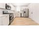 White cabinets, stainless steel appliances, and quartz countertops in this kitchen at 6005 W Washington Ave, Las Vegas, NV 89107