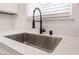 Modern kitchen sink with a black gooseneck faucet and white quartz countertop at 6005 W Washington Ave, Las Vegas, NV 89107